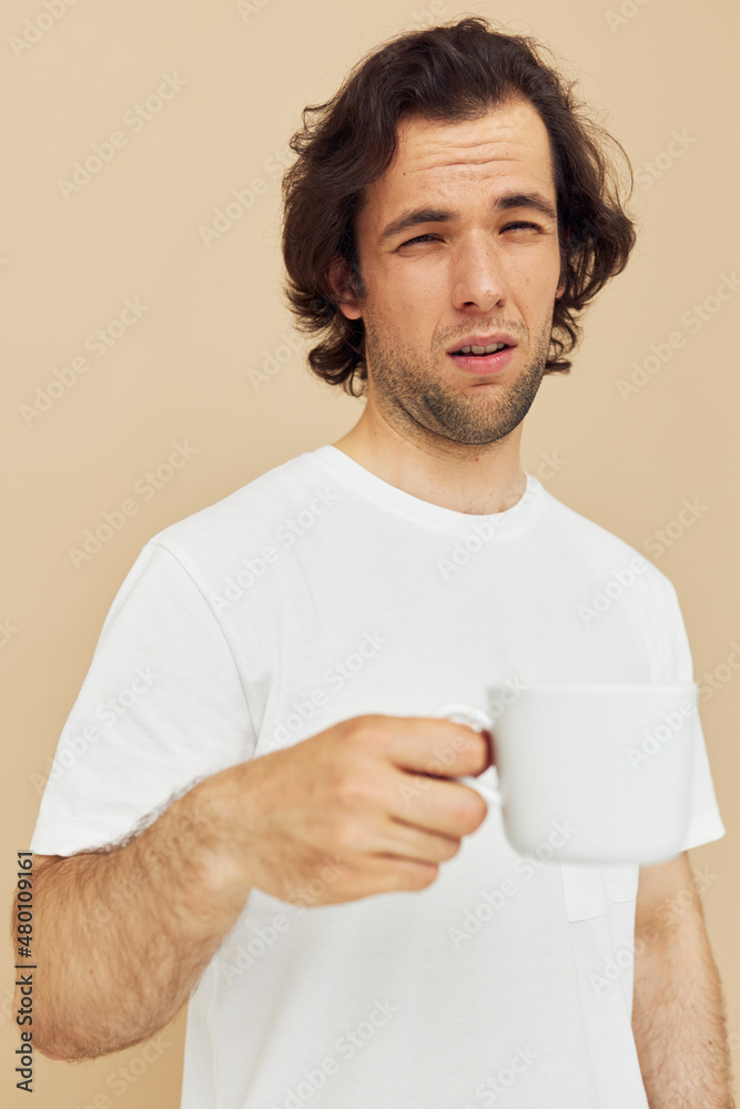 man with a white mug in his hands emotions posing isolated background man with a white mug in his hands emotions posing isolated background