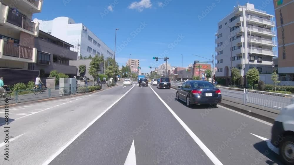 A pov of driving cityscape on the city street in Tokyo in summer wide shot A pov of driving cityscape on the city street in Tokyo in summer wide shot