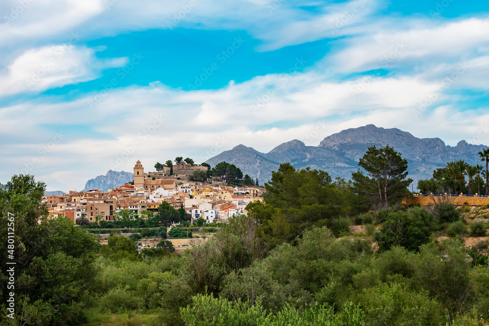 The ancient Spanish city of Polop in the province of Alicante, Costa Blanca against the backdrop of beautiful landscapes, mountains and blue sky with clouds. Travel and family vacation concept.