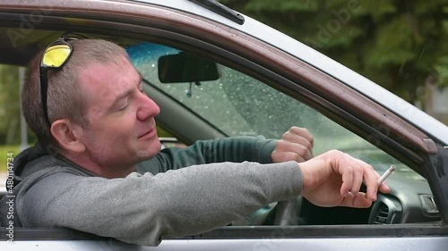 The driver with a cigarette welcomes and beckons the passenger to get into the car