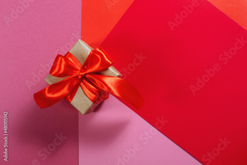 Gifts in kraft paper with red ribbon.