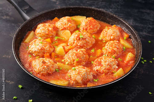 Meatballs with pumpkin and potato slices in tomato sauce. Diet food. Healthy food