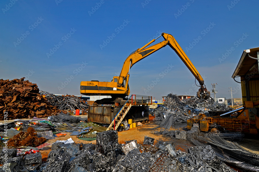 Scrap pile tidying with excavator