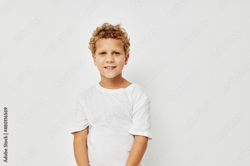 Photo of young boy smile in white t-shirt isolated background Photo of young boy smile in white t-shirt isolated background