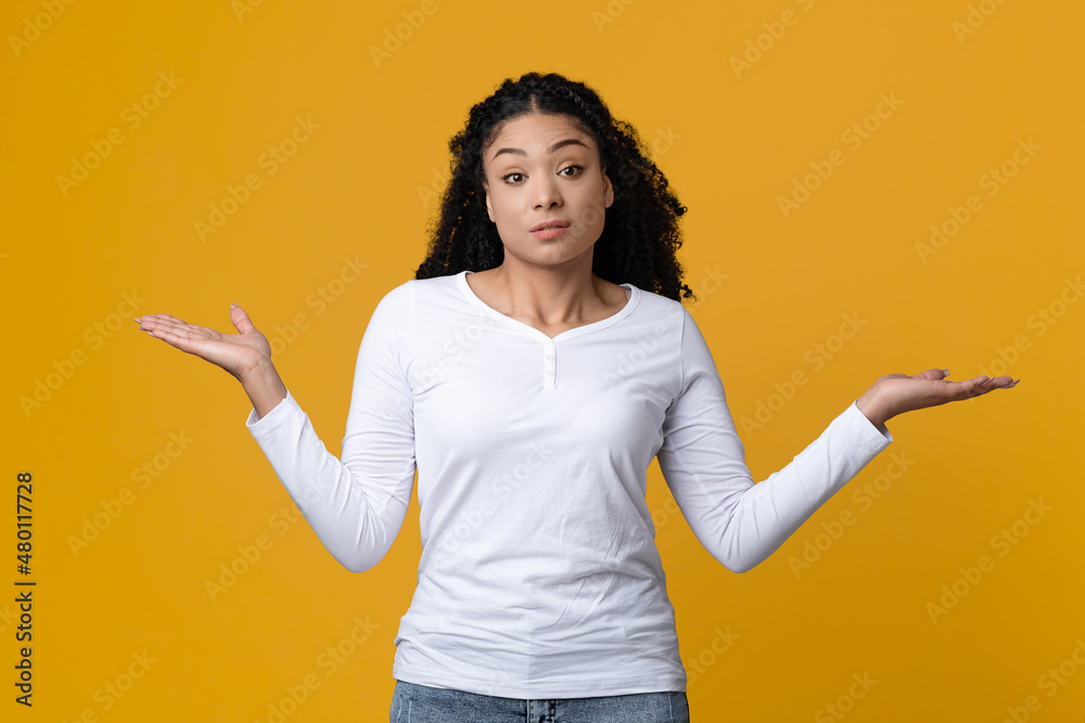 Who Knows. Doubtful African American Woman Shrugging Shoulders And Spreading Arms Who Knows. Doubtful African American Woman Shrugging Shoulders And Spreading Arms