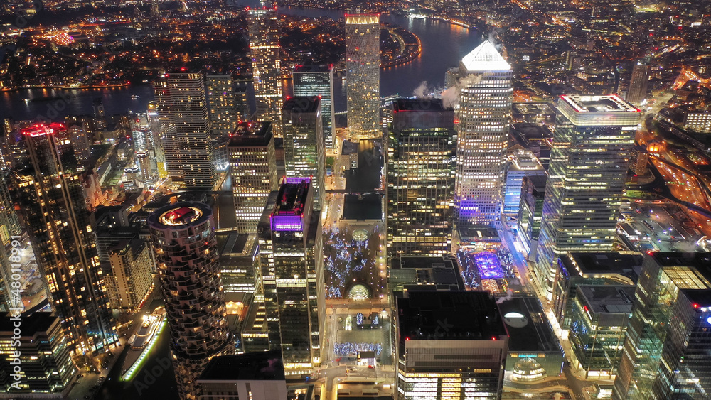 Aerial drone night shot of iconic illuminated with Christmas lights skyscraper banking and business complex of Canary Wharf, Docklands, London, United Kingdom Aerial drone night shot of iconic illuminated with Christmas lights skyscraper banking and business complex of Canary Wharf, Docklands, London, United Kingdom