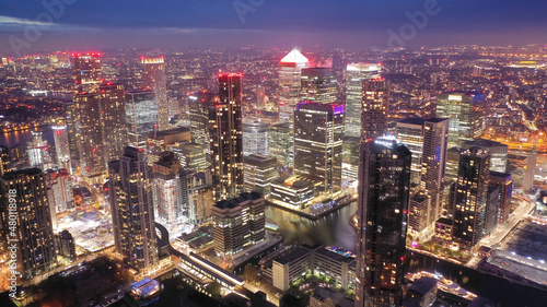 Aerial drone night shot of iconic illuminated with Christmas lights skyscraper banking and business complex of Canary Wharf  Docklands  London  United Kingdom