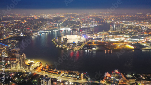 Aerial drone night shot of iconic illuminated with Christmas lights O2 entertainment complex in North Greenwich, London, United Kingdom