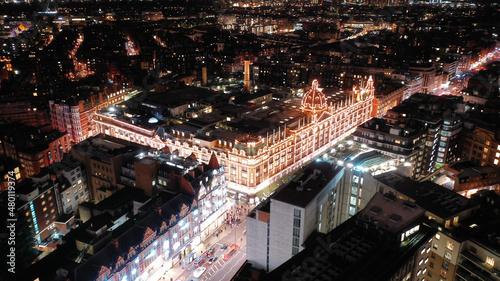 Aerial drone night shot of iconic illuminated Harrods department store at Knightsbridge at Christmas time, London, United Kingdom