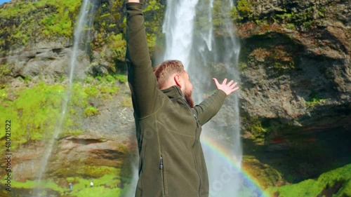 Happy Caucasian Traveler At Seljalandsfoss Waterfalls In Southern Iceland. Medium, Slow Motion photo