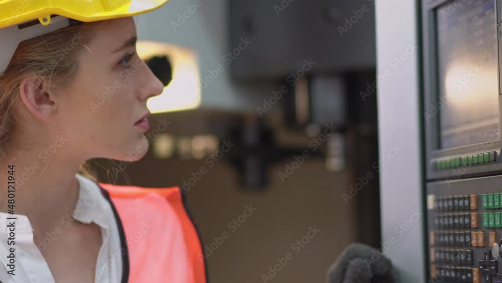 Caucasian female industrial worker or engineer in protective clothing checking and repairing machine in the factory. maintenance system Caucasian female industrial worker or engineer in protective clothing checking and repairing machine in the factory. maintenance system