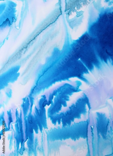Blue watercolor background. Transparent lines and spots. Paint leaks and ombre effects. Abstract hand-painted image.