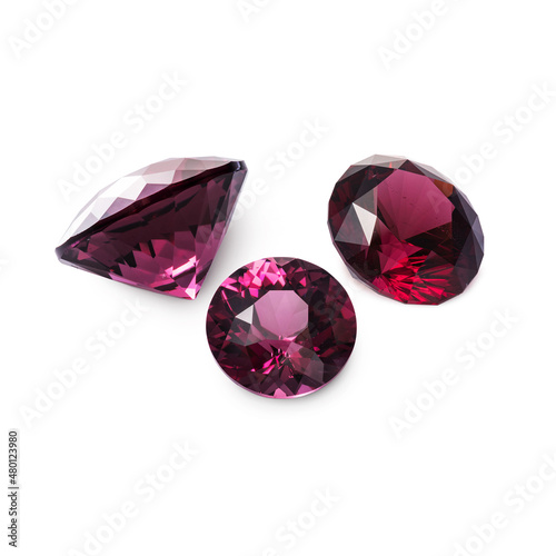 Three faceted red rhodolite garnets isolated on white background photo
