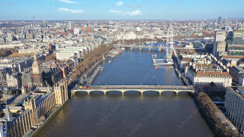Aerial drone photo of iconic giant Ferris Wheel of London eye in front of river Thames and houses of Parliament and Big Ben at the background, Westminster, United Kingdom