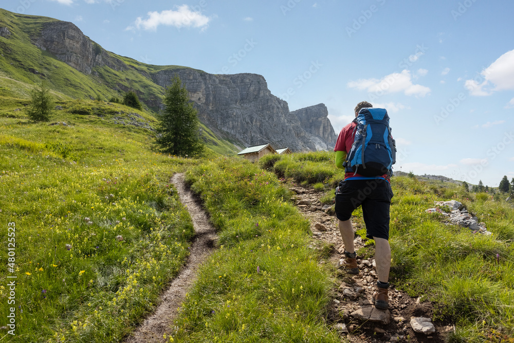Man hiking up a beautiful trail in the Dolomite Mountains