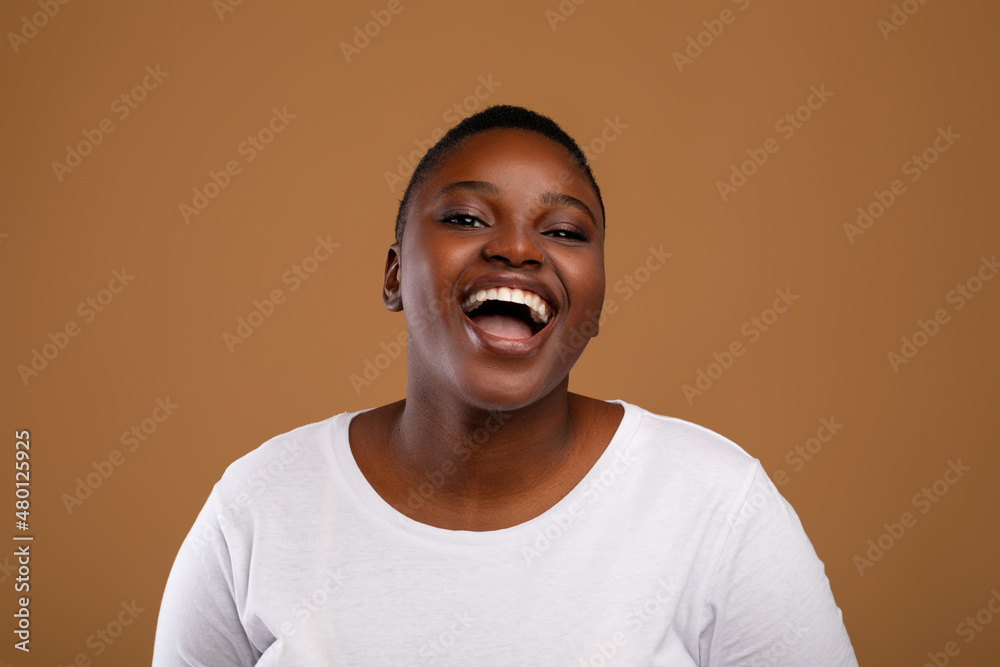 Portrait of casual young chubby black woman laughing Portrait of casual young chubby black woman laughing