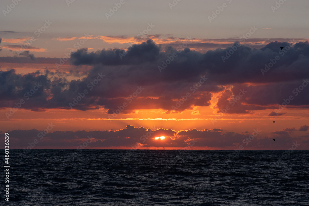 sunset on sea coast orange with sun and clouds
sunset on sea coast orange with sun and clouds
