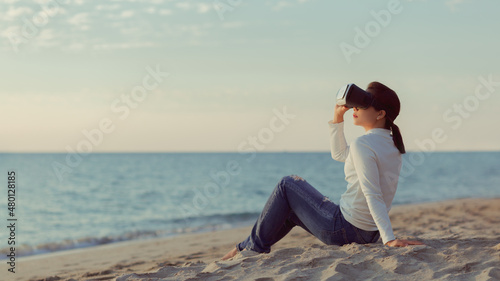 Woman testing outdoor digital technology VR glasses 