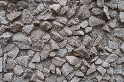 Surface of light gray gravel pebble dash on the wall photo