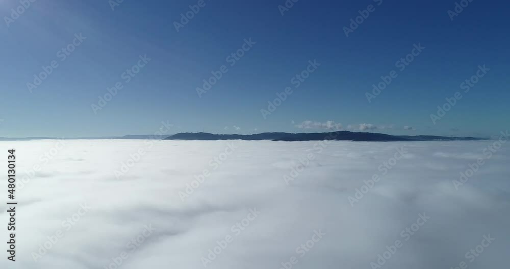 Smooth drone reveal of large fog cloud base below. Smooth drone reveal of large fog cloud base below.