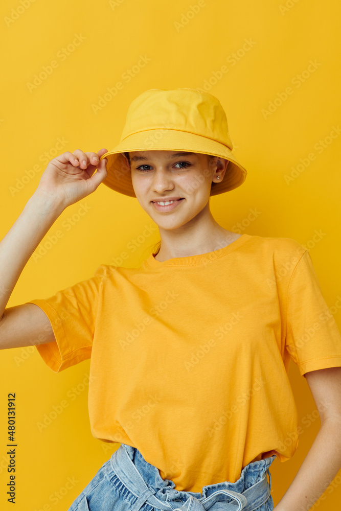 beautiful girl in a yellow t-shirt and Hat emotions summer style isolated background beautiful girl in a yellow t-shirt and Hat emotions summer style isolated background
