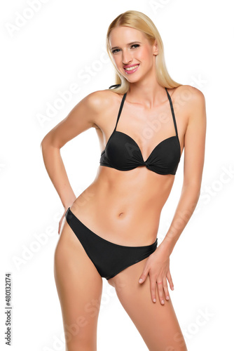 Young blond smiling woman posing in swimsuit