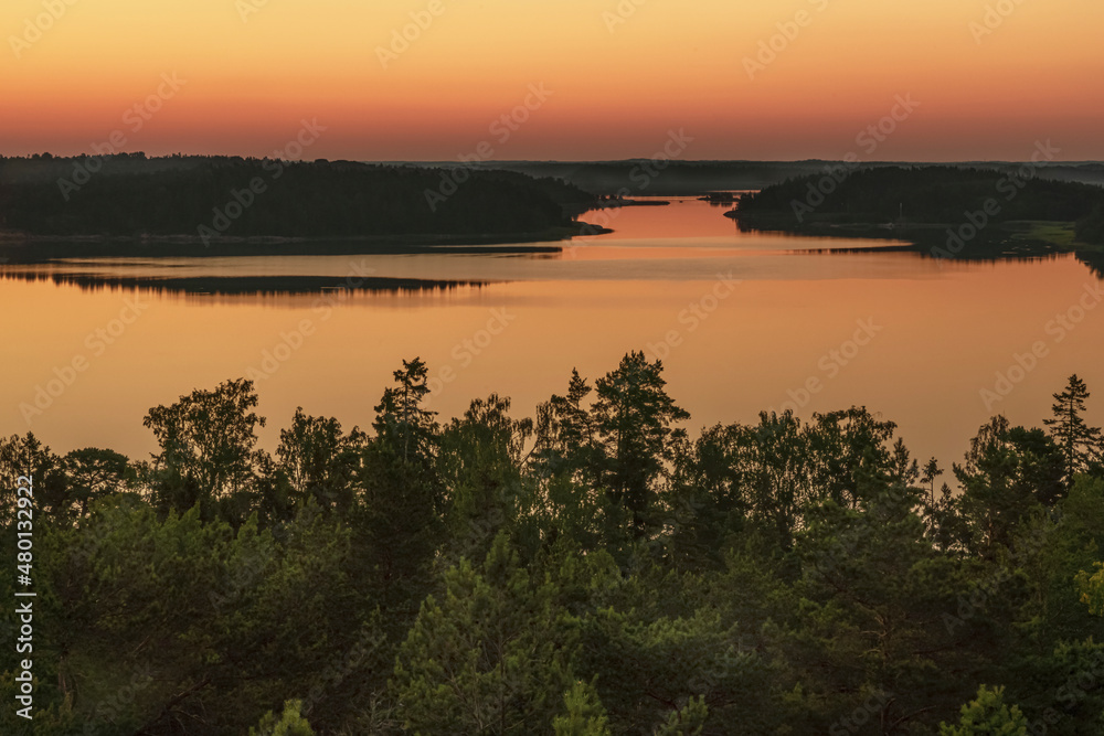 Fototapeta premium Early, summer dawn, over the sea. Nature of Scandinavia. Islands in the sea. Finland.