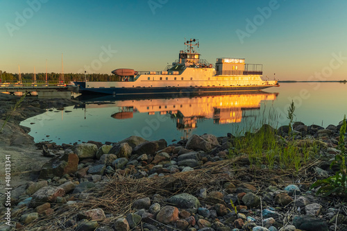 Ferry at the pier. Early, summer dawn. Nature of Scandinavia. Islands in the sea. Finland.