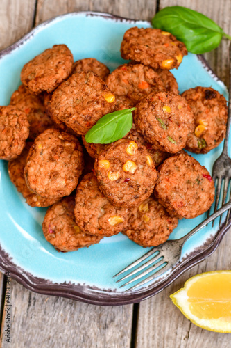 Home made  oven baked  mini meatballs  from  chicken and vegetable on  wooden background