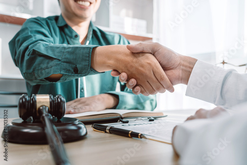 Businessman shaking hands with professional lawyer after discussing a good deal of contract in the courtroom, Handshake after good cooperation