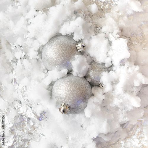 snowy frozen metallic iced background with silver balls coming out of it.holidays Christmas concept idea.New Year aesthetic