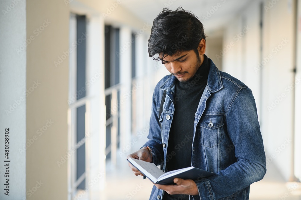 Happy indian male student at the university