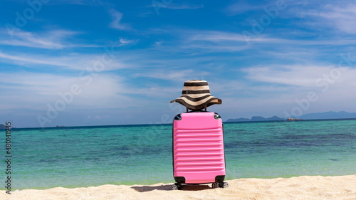 Summer travel concept with Pink luggage on the white sand Beach background banner travel image © SASITHORN