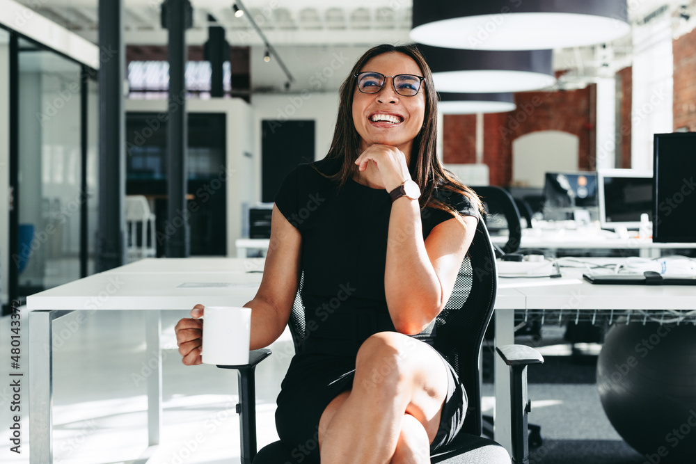 Happy businesswoman feeling cheerful in a modern office Happy businesswoman feeling cheerful in a modern office