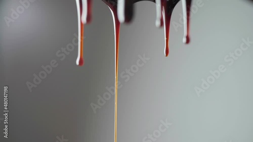 Drops of chocolate are dripping.