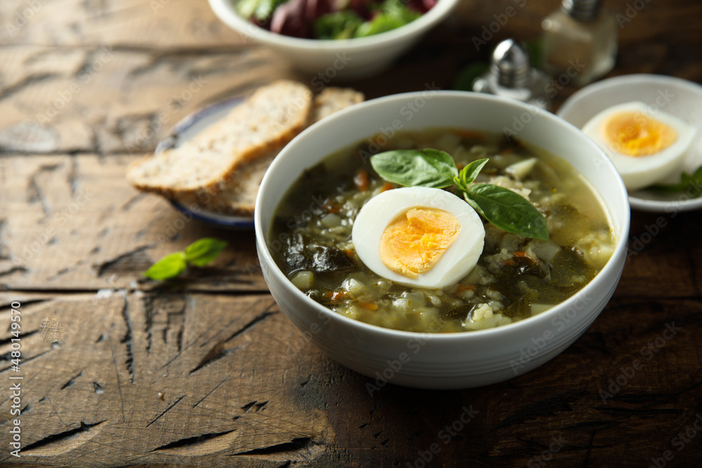 Traditional homemade green soup with hard boiled eggs