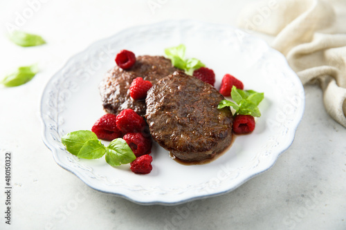 Homemade meat chops with raspberry and mint