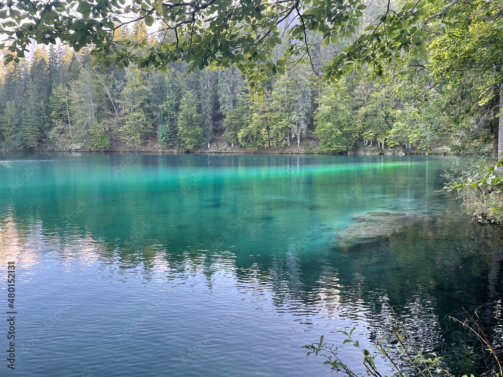 The Fusine lakes in Friuli Venezia Giulia Italy. Mountain lake, trees and lake, mountain and lake, lake and mountain panorama, blue water on the lake. The Fusine lakes in Friuli Venezia Giulia Italy. Mountain lake, trees and lake, mountain and lake, lake and mountain panorama, blue water on the lake.