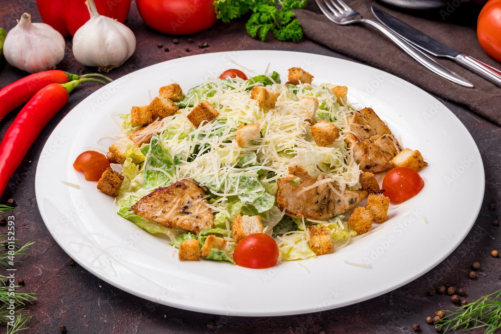 Salad caesar with chicken on white plate