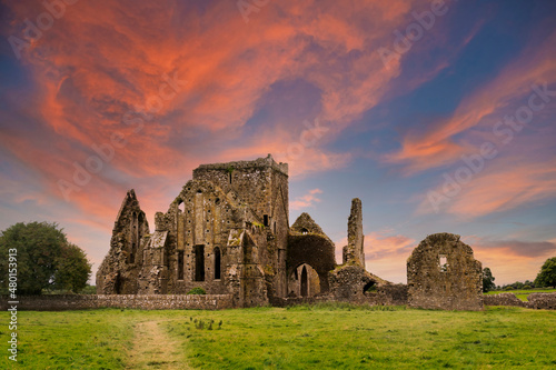 Ruins of Hore Abbey at sunset with reddish clouds  near the Irish village of Cashel. Built by Benedictine monks in the 13th century.