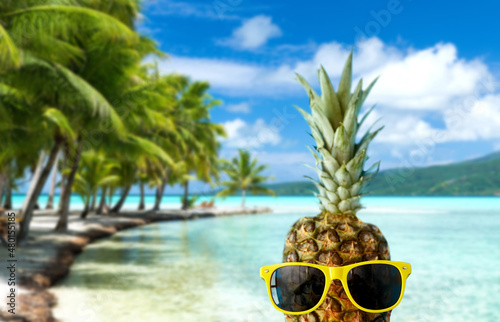Obraz na plátně summer holidays, travel and tourism concept - close up of pineapple in yellow su