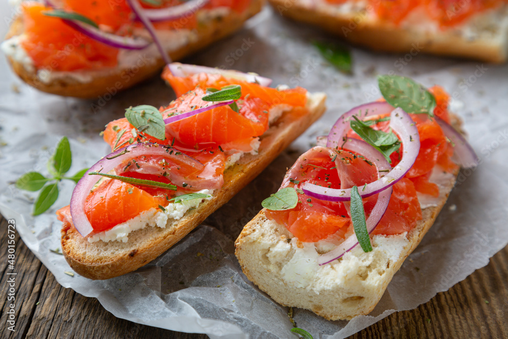 Sandwich with smoked salmon and cream cheese on a crispy baguette Sandwich with smoked salmon and cream cheese on a crispy baguette