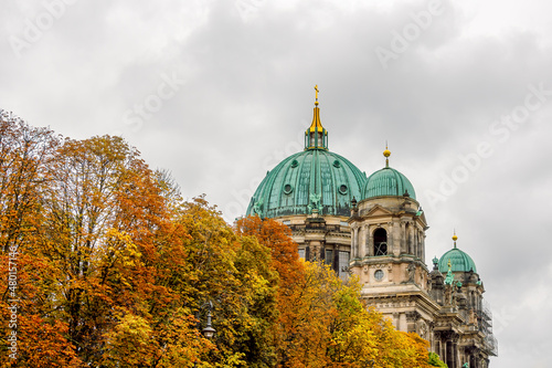 Photography The dome of the Berlin Cathedral ( Berliner Dom ) and the colorful autumn crowns of the trees in the foreground on a cloudy day