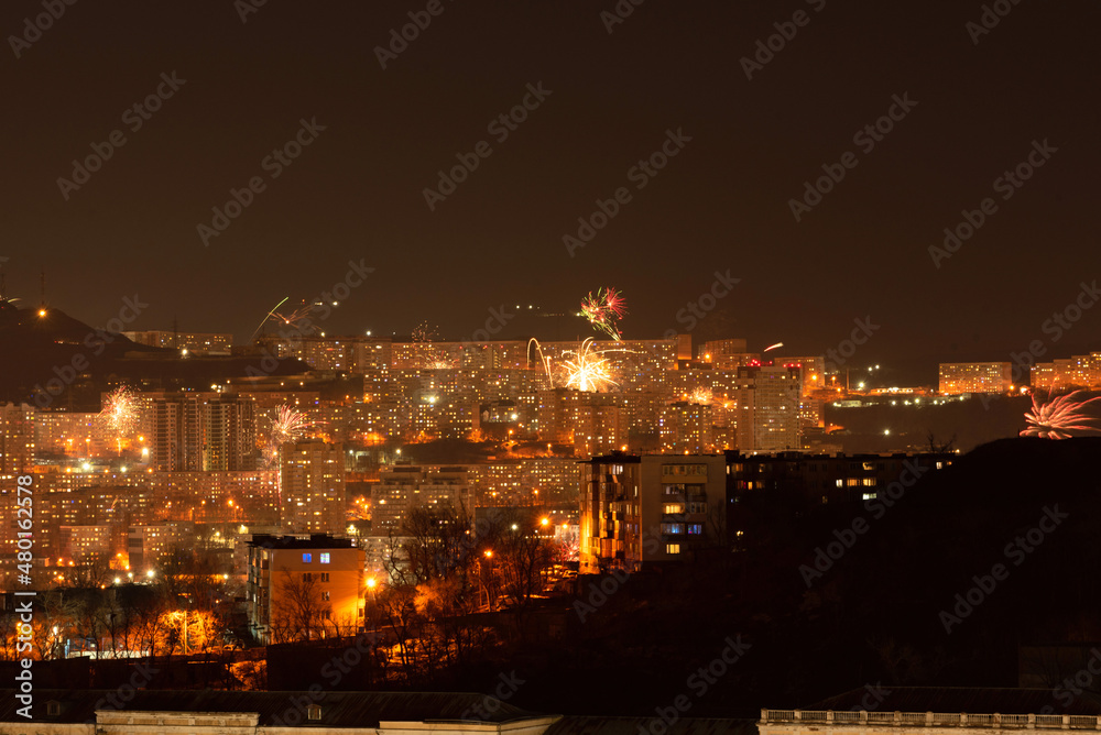 Fireworks in the city at night during New Year celebration. Soft focus background