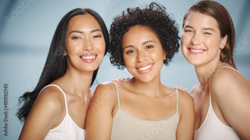 Beauty Portrait of Three Diverse Multiethnic Models on Isolated Background. Laughing Happy Asian, Black and Caucasian Women with Natural, Healthy Skin. Wellness, Spa, Cosmetology, Skincare Concept.