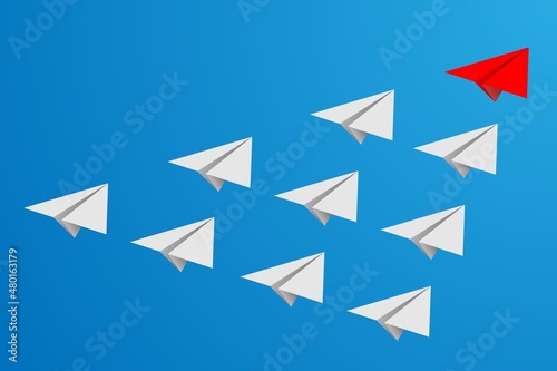 Individual red leader paper plane lead other on blank copy space background. Business and leadership concept