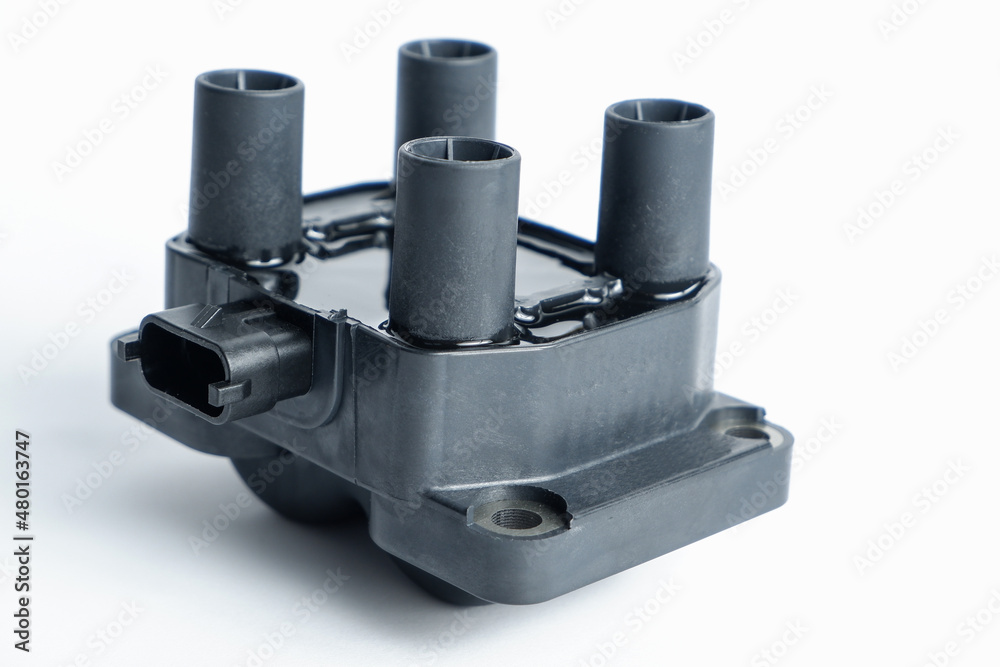 Auto parts. Car ignition coil on a white background close-up. Ignition coil for gasoline four-cylinder internal combustion engine Auto parts. Car ignition coil on a white background close-up. Ignition coil for gasoline four-cylinder internal combustion engine