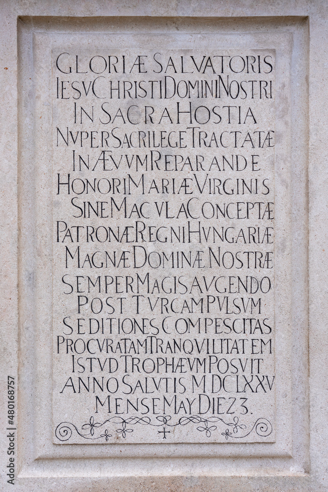 Long inscription engraved in stone in uppercase letters in Latin in late renaissance script, 17th century monument in Bratislava