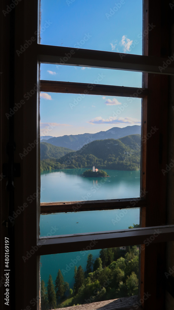 Panoramic view to the lake Bled and surrounding mountains through a window