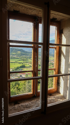 Panoramic view to the Bled town and surrounding mountains through a window